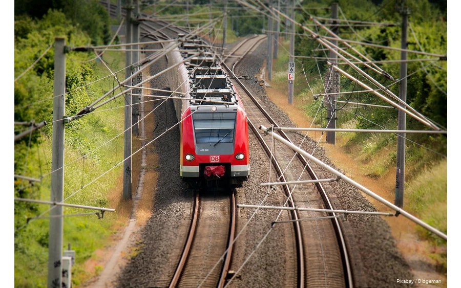 A Deutsche Bahn train travels through the countryside.