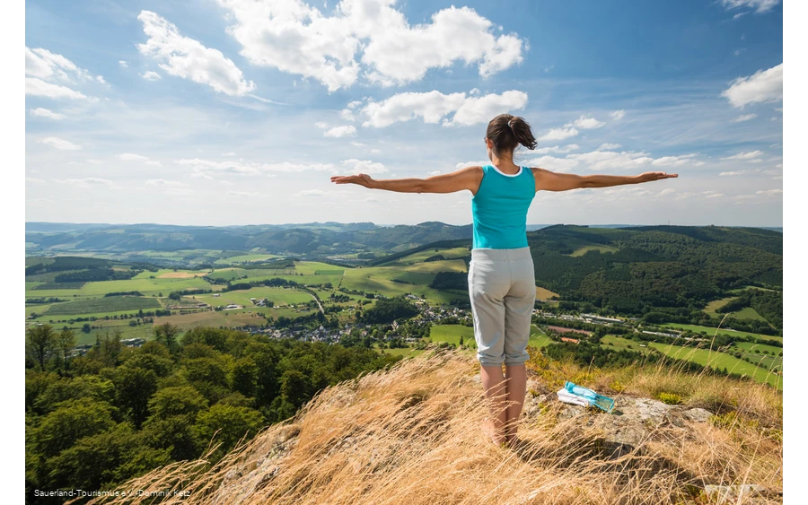 A woman enjoys the sweeping view from the Bruchhauser Steine