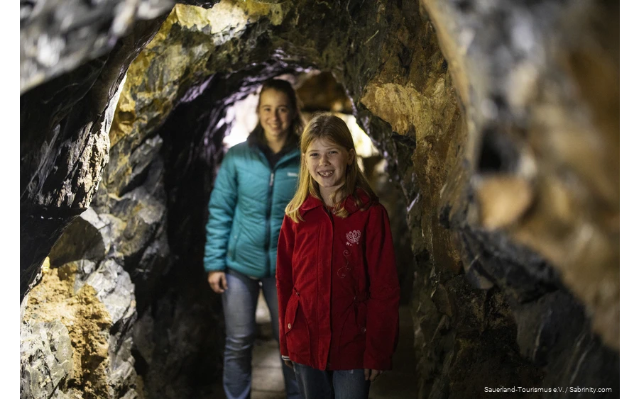 Two girls walk through the Bilstein Cave.