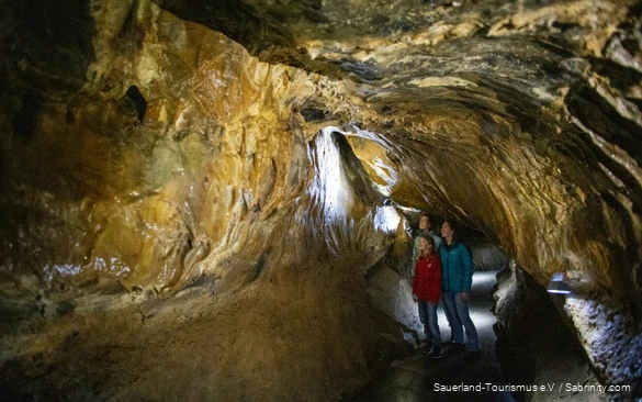 A mother marvels at the Bilstein Cave with her two daughters.