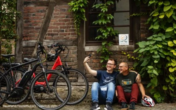 Two cyclists take a break with a bike-friendly host.