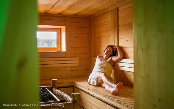 A woman relaxes in the sauna.