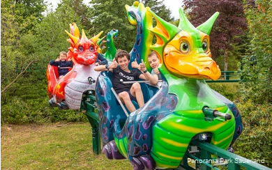 Lächelnde Kinder in der Drachenbahn im Panorama Park