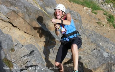 Woman climbing on the rock.