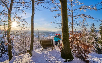 A couple enjoying the winter sun in the snow.