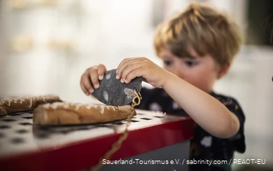 A boy plays at an interactive hands-on station at the Südsauerlandmuseum in Attendorn.