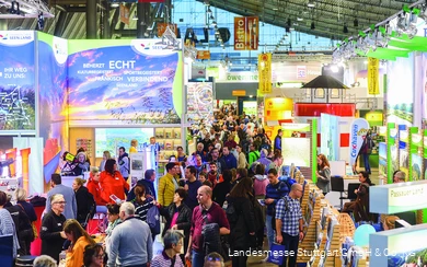 An exhibition hall full of information stands and people