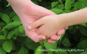 One hand holds the other hand.