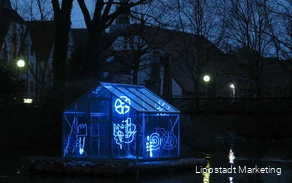 A greenhouse is illuminated with light tubes in various shapes.