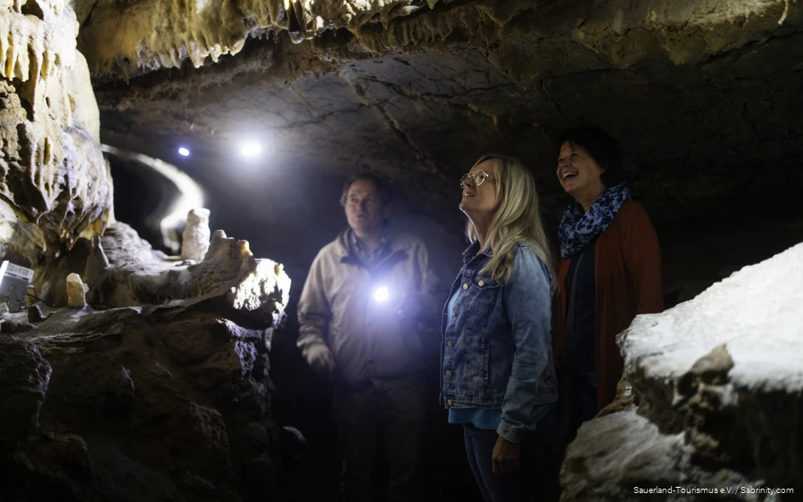 Two women and the cave guide marvel at the cave.