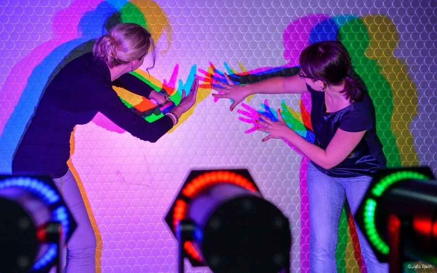 Two women experiment with light and shadow.