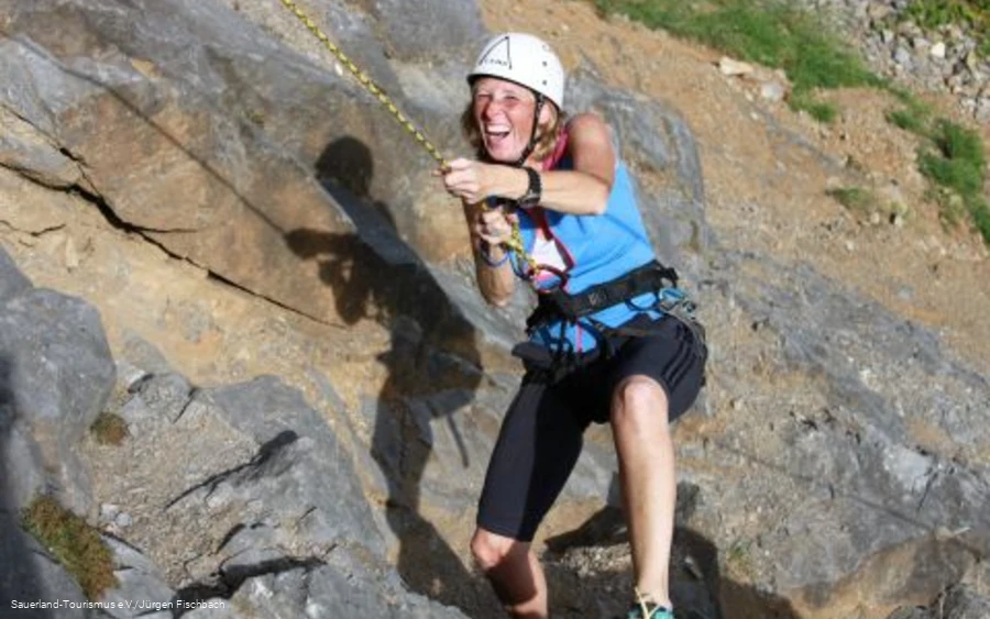 Woman climbing on the rock.