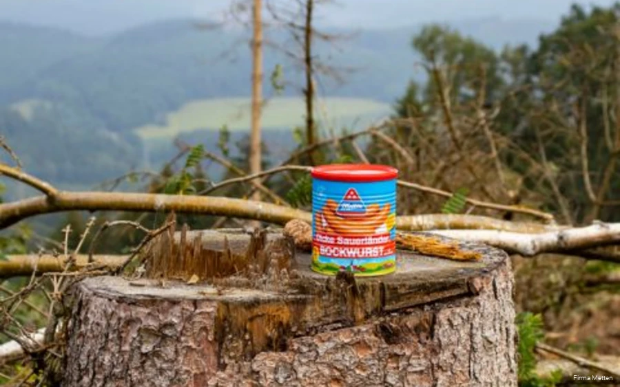 A can of mead on a tree stump.