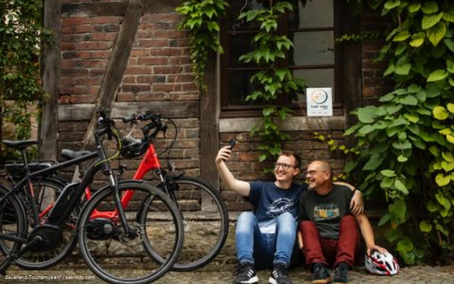 Two cyclists take a break with a bike-friendly host.