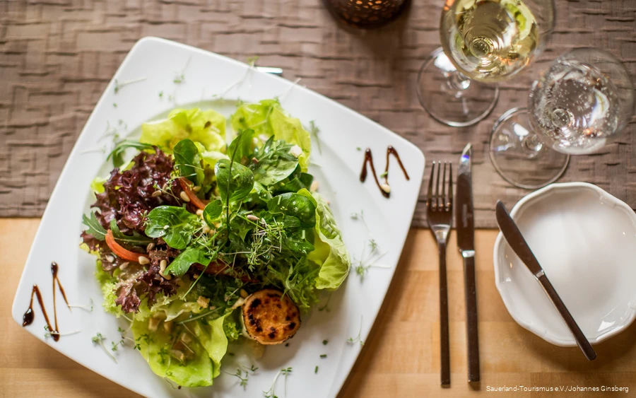 Fresh green salad on a plate in a restaurant.