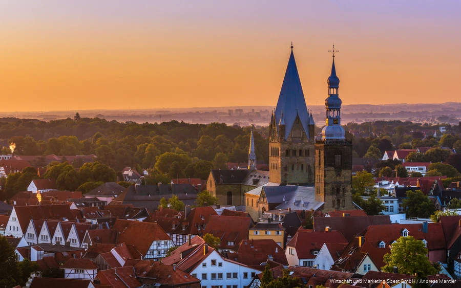 Aerial view of Soest with church in the center and orange sunset sky