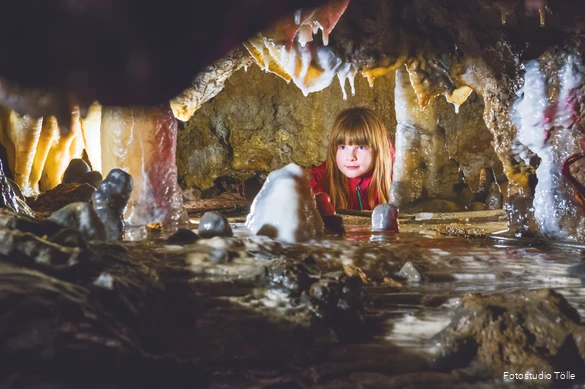 Girl looks at stalactites.