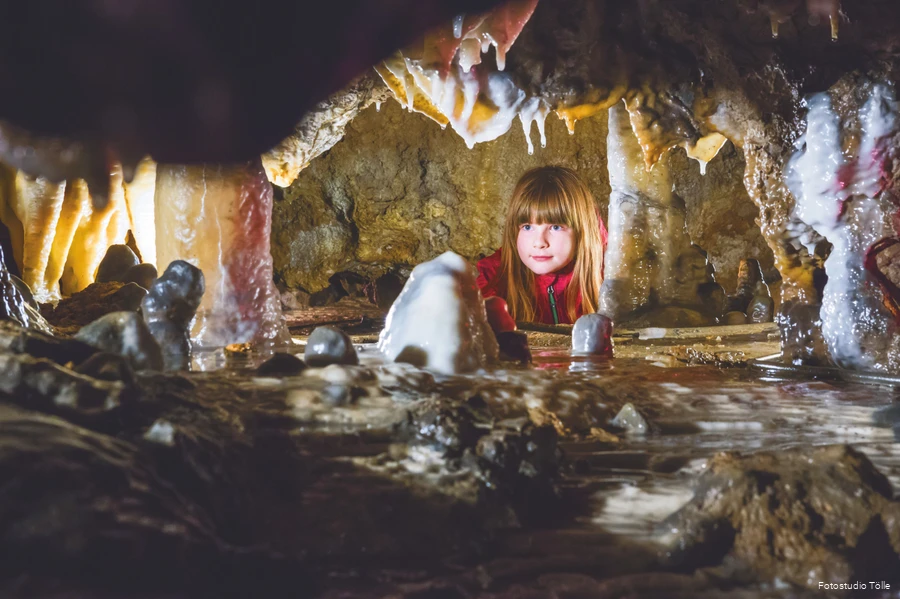 Girl looks at stalactites.