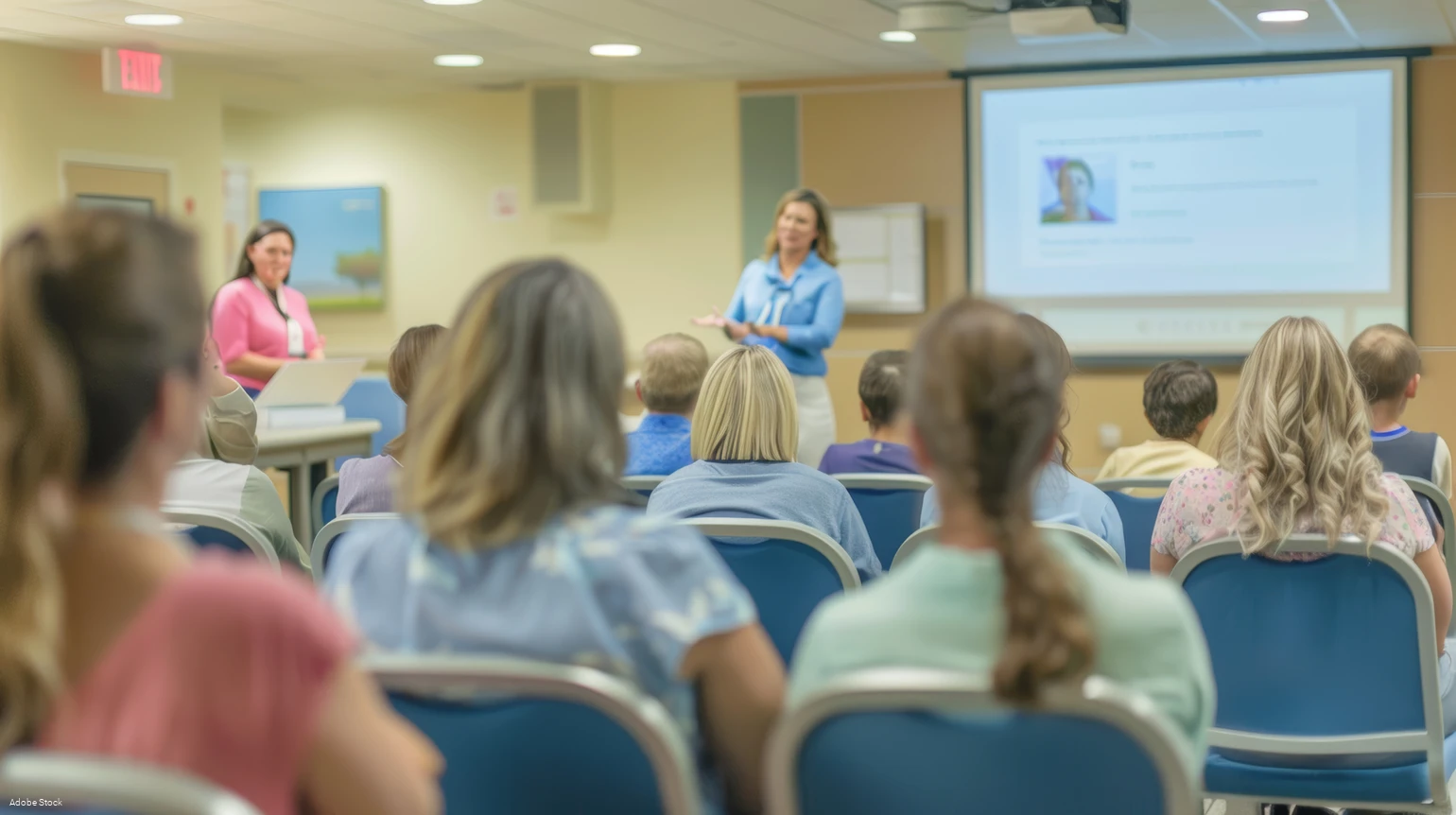 Healthcare Professional Presenting Diabetes Management to Parents in a Conference Room Setting